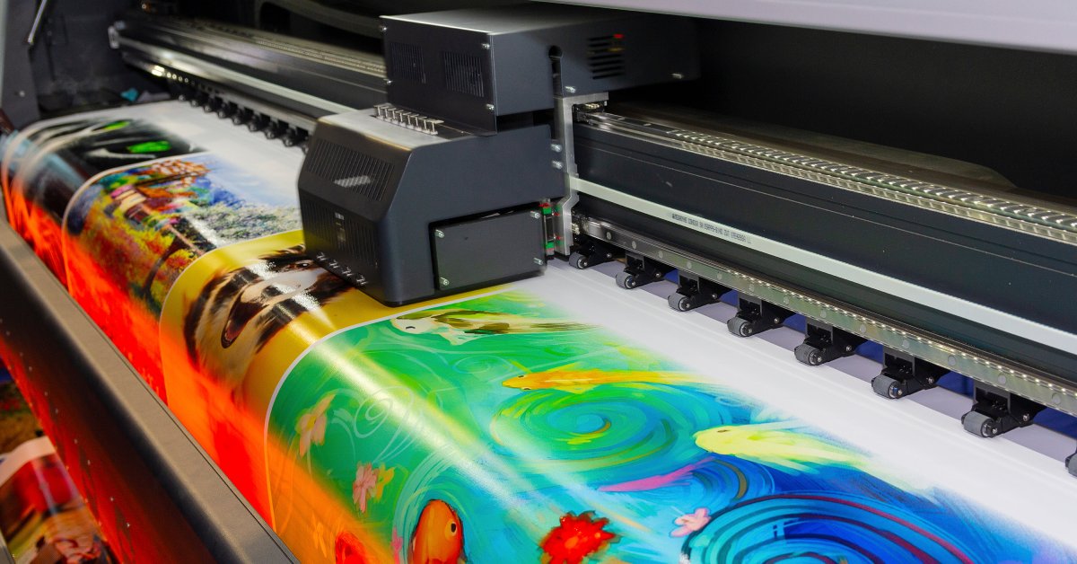 A poster printing machine prints a large poster with vibrant colors and various high-quality designs.