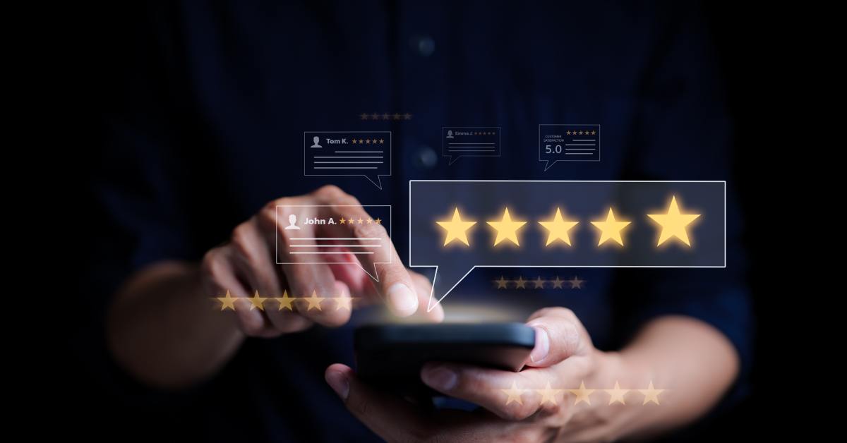 A person holds a smartphone as they tap on the screen. A transparent graphic with 5 yellow stars hovers over the smartphone.